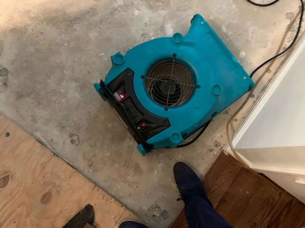 Air mover drying subfloor during Commercial Water Damage Restoration in South Salt Lake